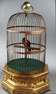 A large Antique hexagonal base antique single singing bird-in-cage, by Bontems