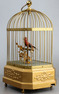 Vintage single singing bird in cage, by Karl Griesbaum