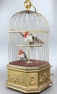 Antique double singing cockatiels-in-cage, by Bontems