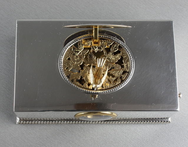 Contempary sterling silver, gold and diamond singing bird box with timepiece, by Reuge