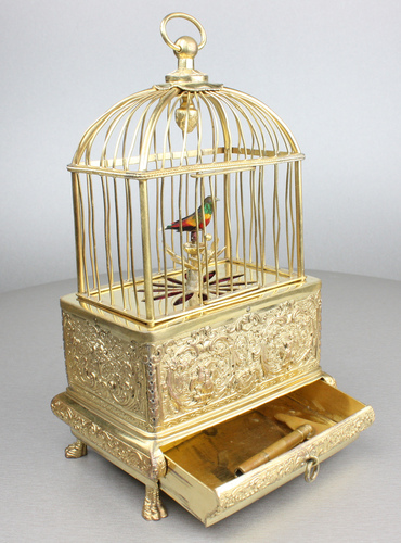 Vintage miniature gilt brass singing bird in cage, by Eschle